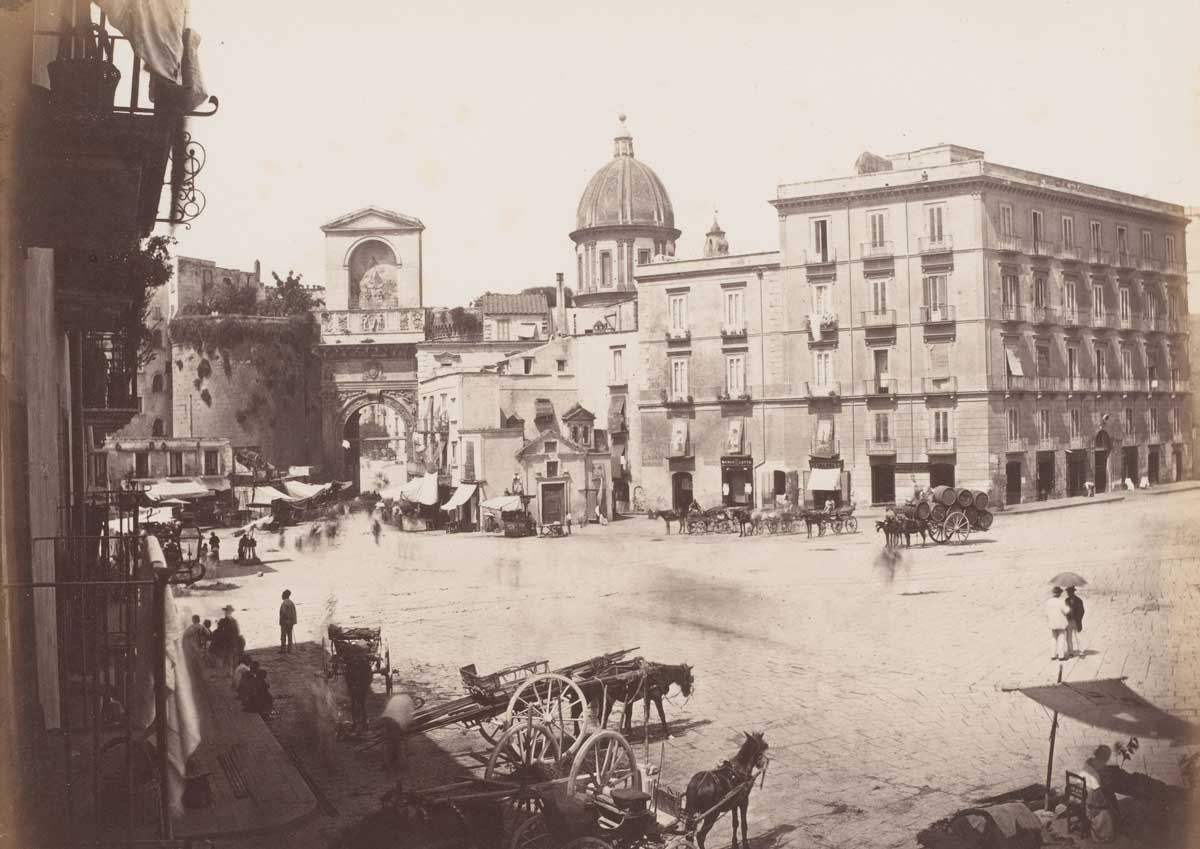 View of a square with the Porta Capuana in the background and the dome of the Santa Caterina a Formiello in Naples, Italy. Photographed by Giorgio Sommer between 1857 and 1914. Rijksmuseum. View of a square with the Porta Capuana in the background and the dome of the Santa Caterina a Formiello in Naples, Italy. Photographed by Giorgio Sommer between 1857 and 1914. Rijksmuseum.